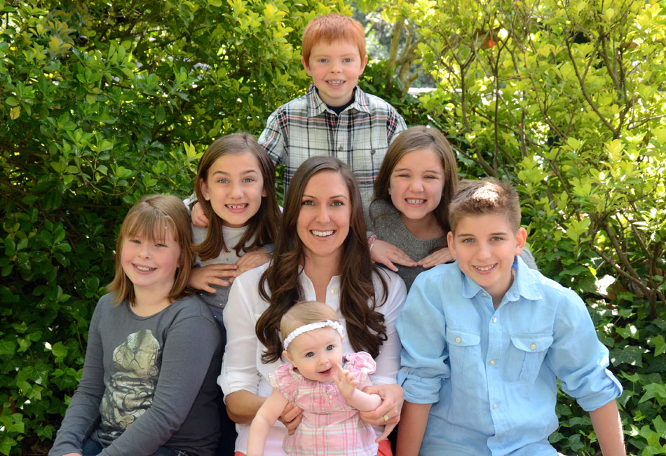Pediatric dentist Dr. Patrice Espinosa and a group of kids sitting together