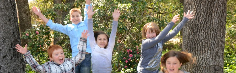 Group of kids jumping and laughing
